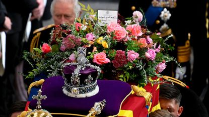 King Charles III walks alongside the coffin carrying Queen Elizabeth II with the Imperial State Crown resting on top as it departs Westminster Abbey during the State Funeral of Queen Elizabeth II on September 19, 2022 in London, England.
