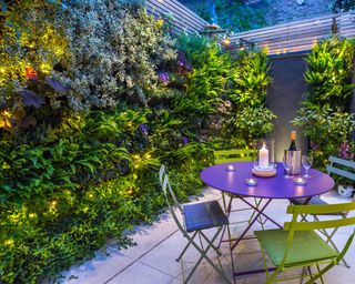 garden with illuminated living wall and bistro set designed by Maitanne Hunt and constructed by The Garden Builders