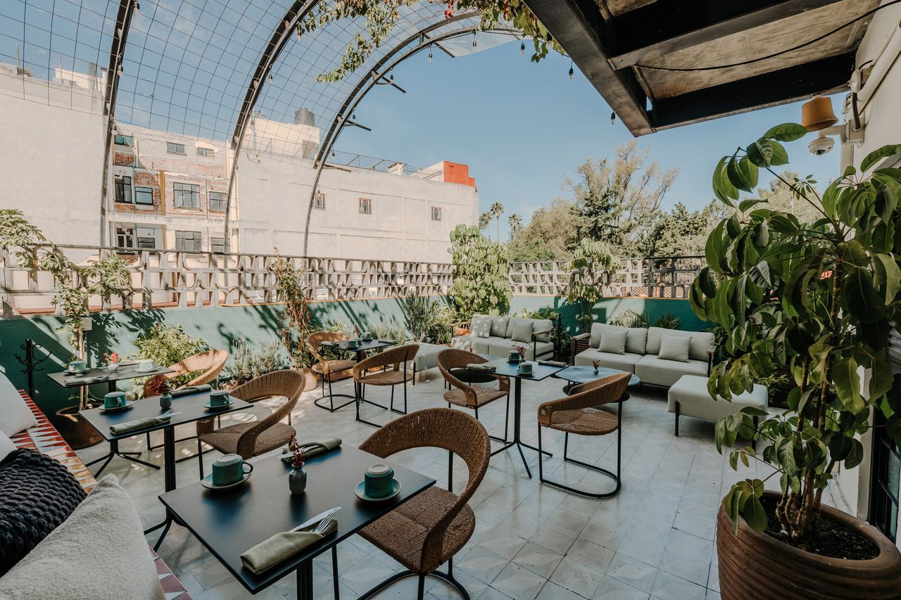 A vibrantly decorated hotel featuring a pastel palette of pinks, greens, and browns, tiled surfaces, and a vaguely Art Deco, contemporary feel.