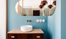 a blue bathroom with dark brown accents