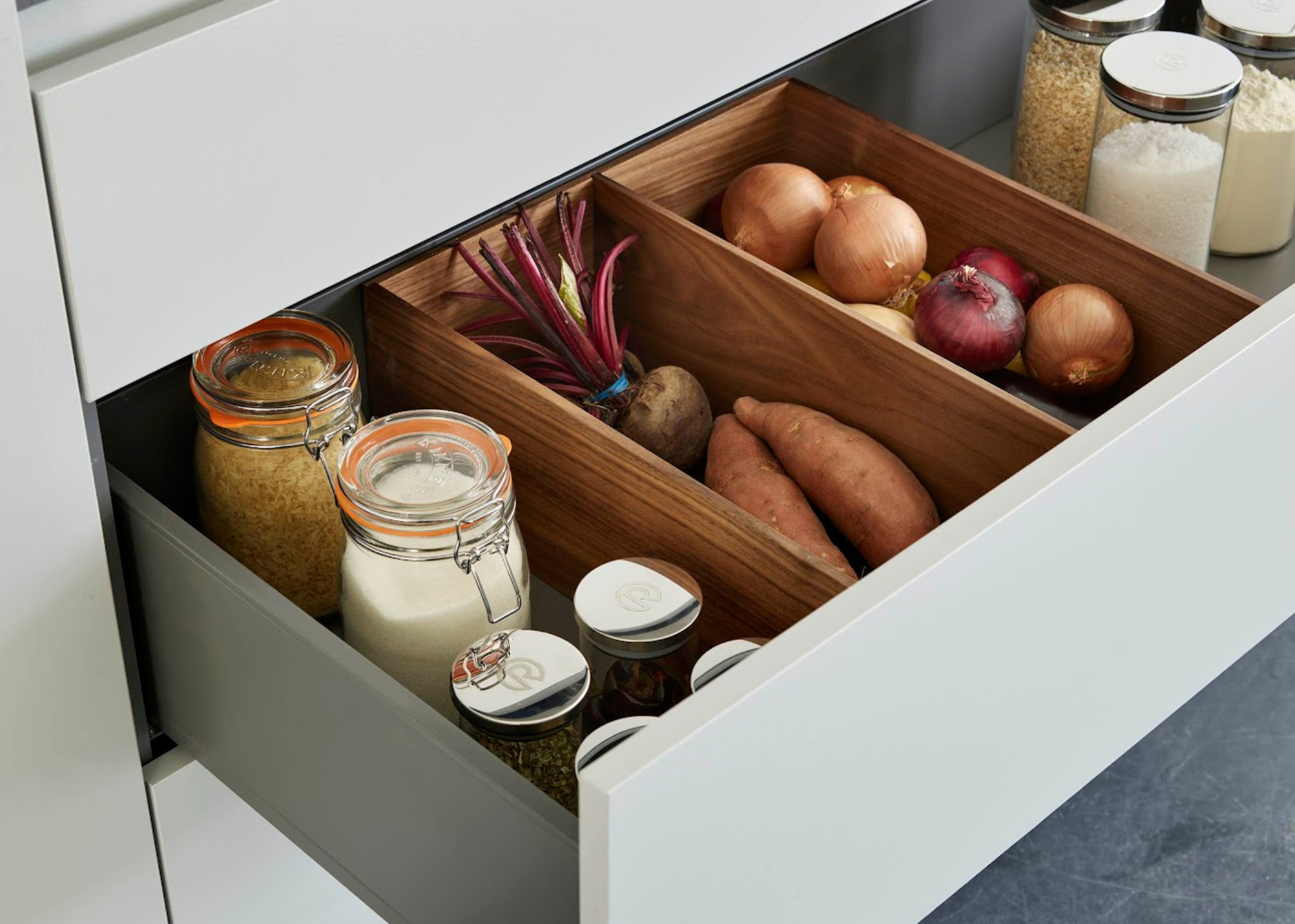 A kitchen drawer with vegetable box dividers