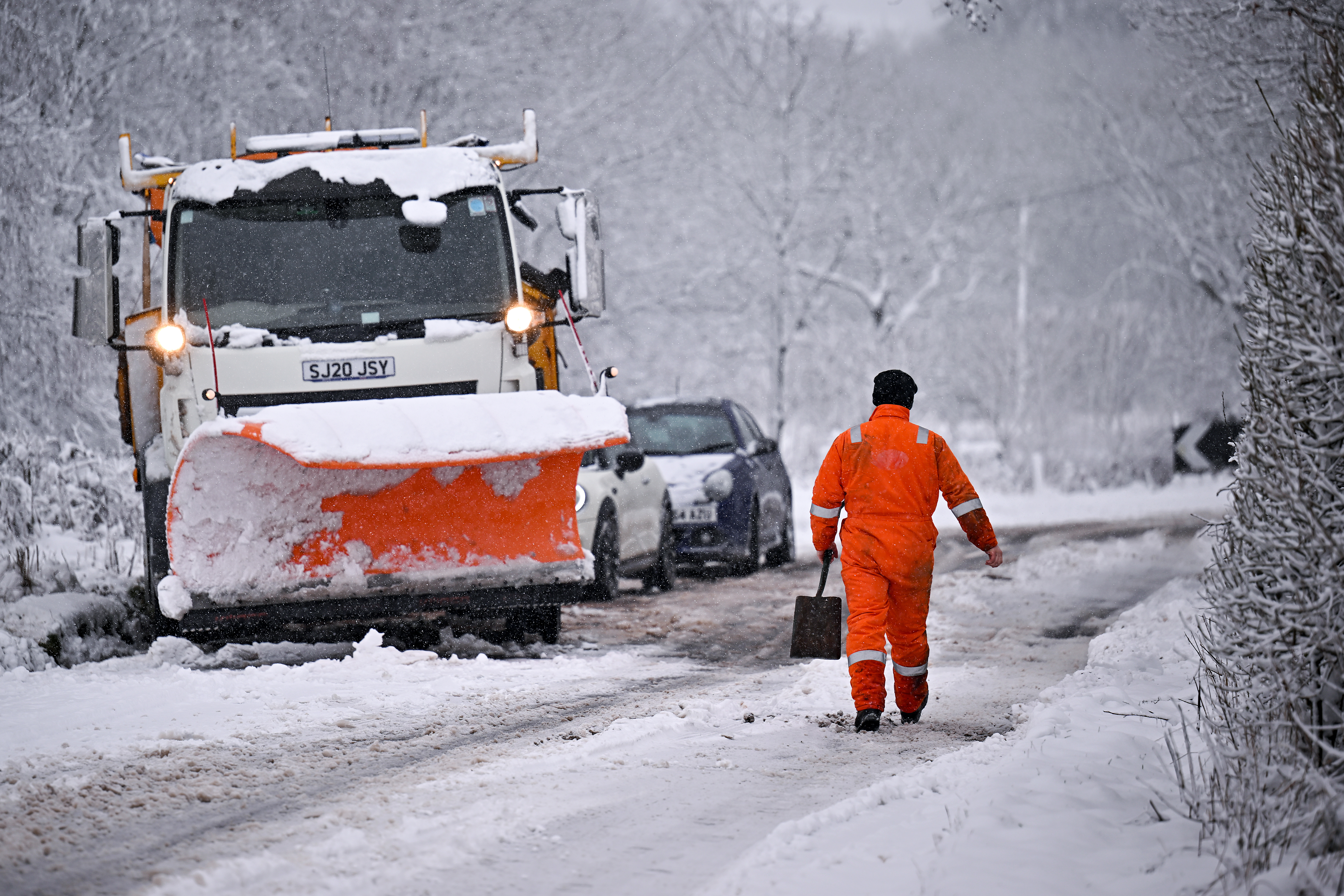 A snow plough receives assistance after coming off the road on February 18, 2022 in Balfron as Storm Eunice arrived.