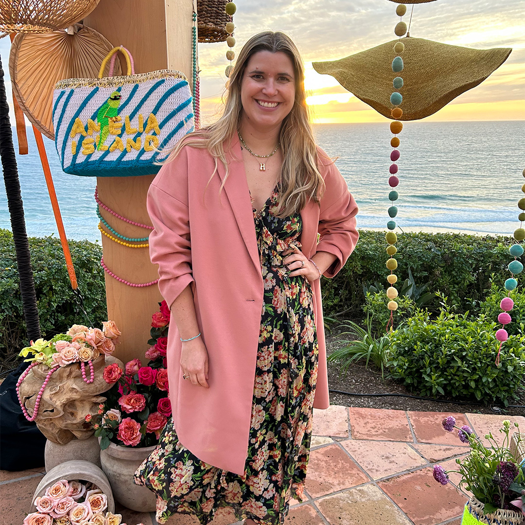 Who What Wear Entertainment Director Jessica Baker at The Ritz-Carlton, Laguna Niguel party for the Kilometre Paris collaboration. She is wearing a pink coat over a floral print Doen dress.