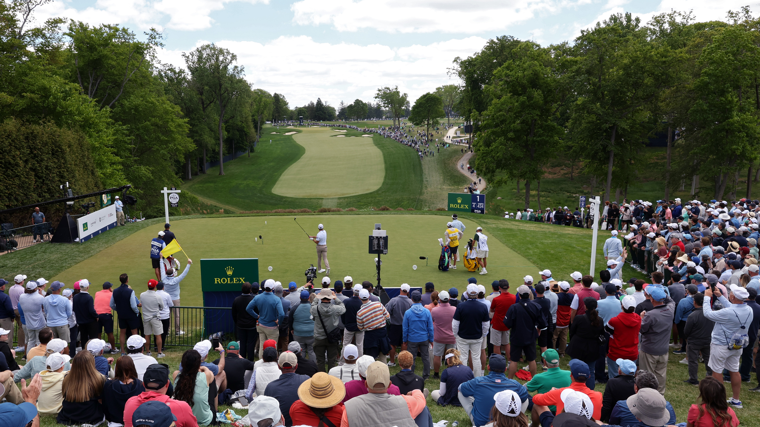 A player tees off the 1st at Aronimink in front of a large crowd at the 2026 PGA Championship
