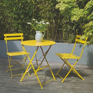 arc Yellow Metal Folding Bistro Table and Chairs Set in garden