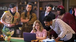 The cast of Ghosts season 2 huddled around a laptop