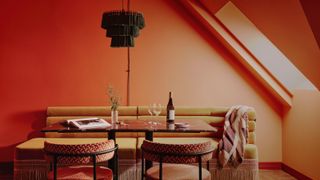 An orange room with mustard sofa