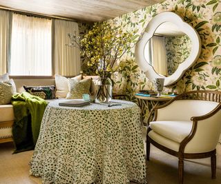 room with floral wallcovering and skirted table