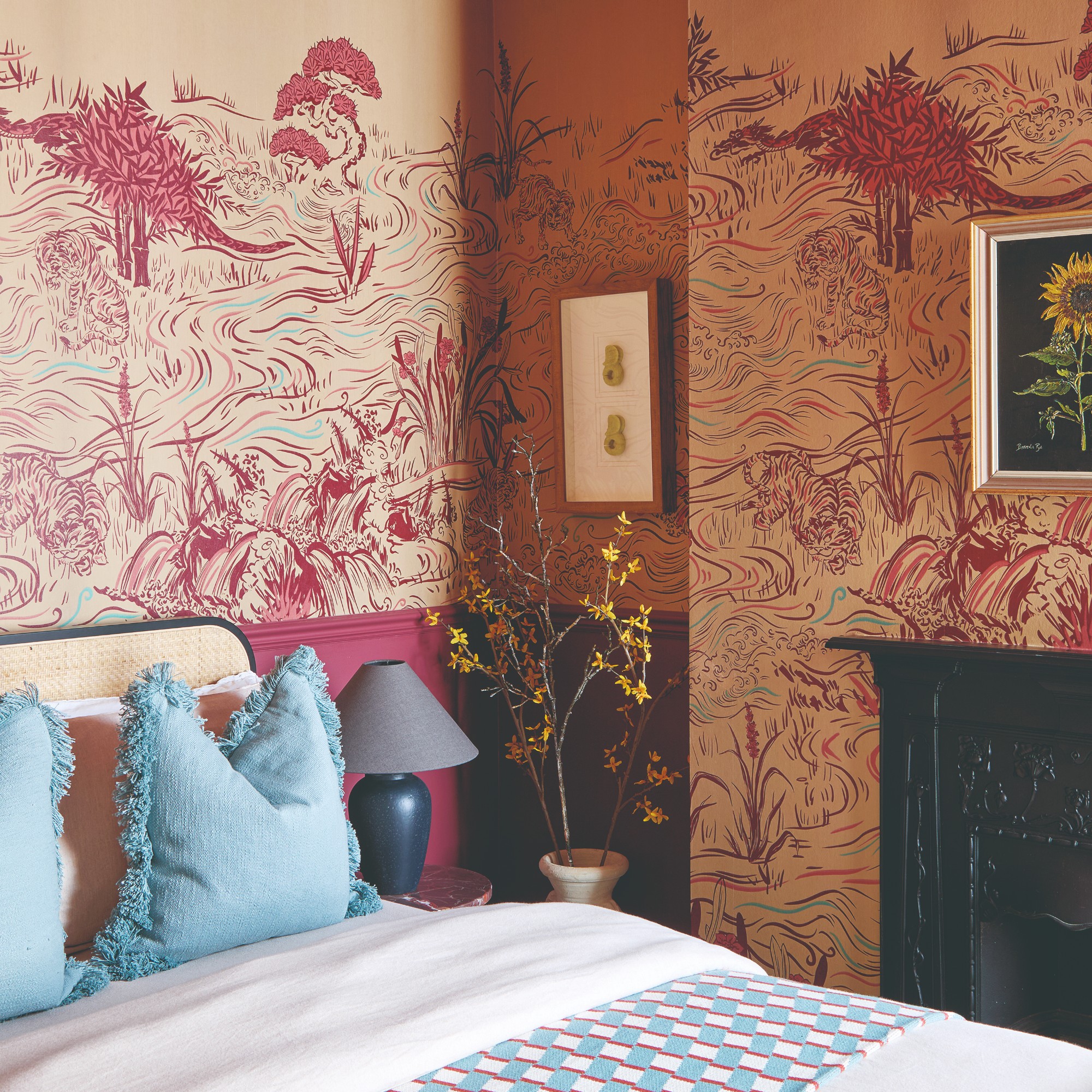 A bedroom with a mural on the walls and a small artwork with a large white mount