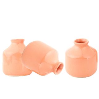 Three round peach colored vases