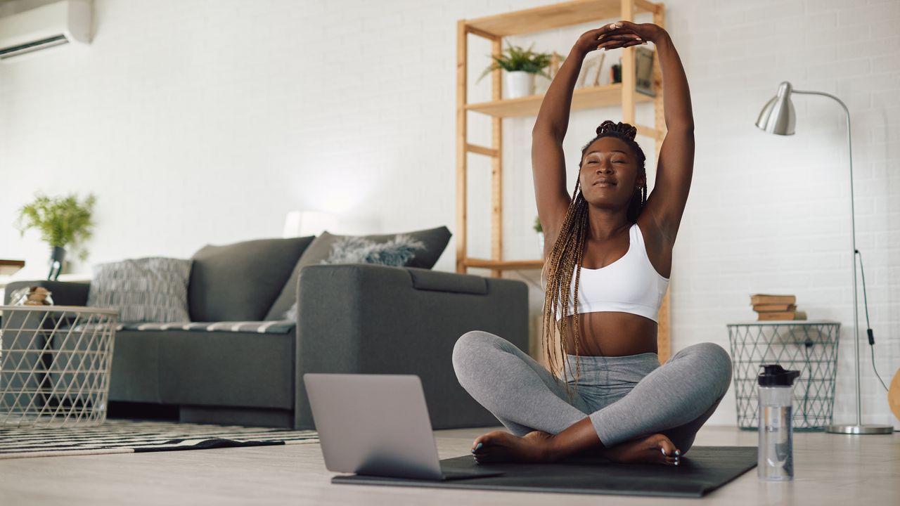 Woman doing yoga stretching at home