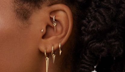 Rook Piercing on an earlobe with maria tash earrings