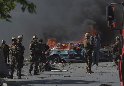 Afghan security forces at a car bomb site
