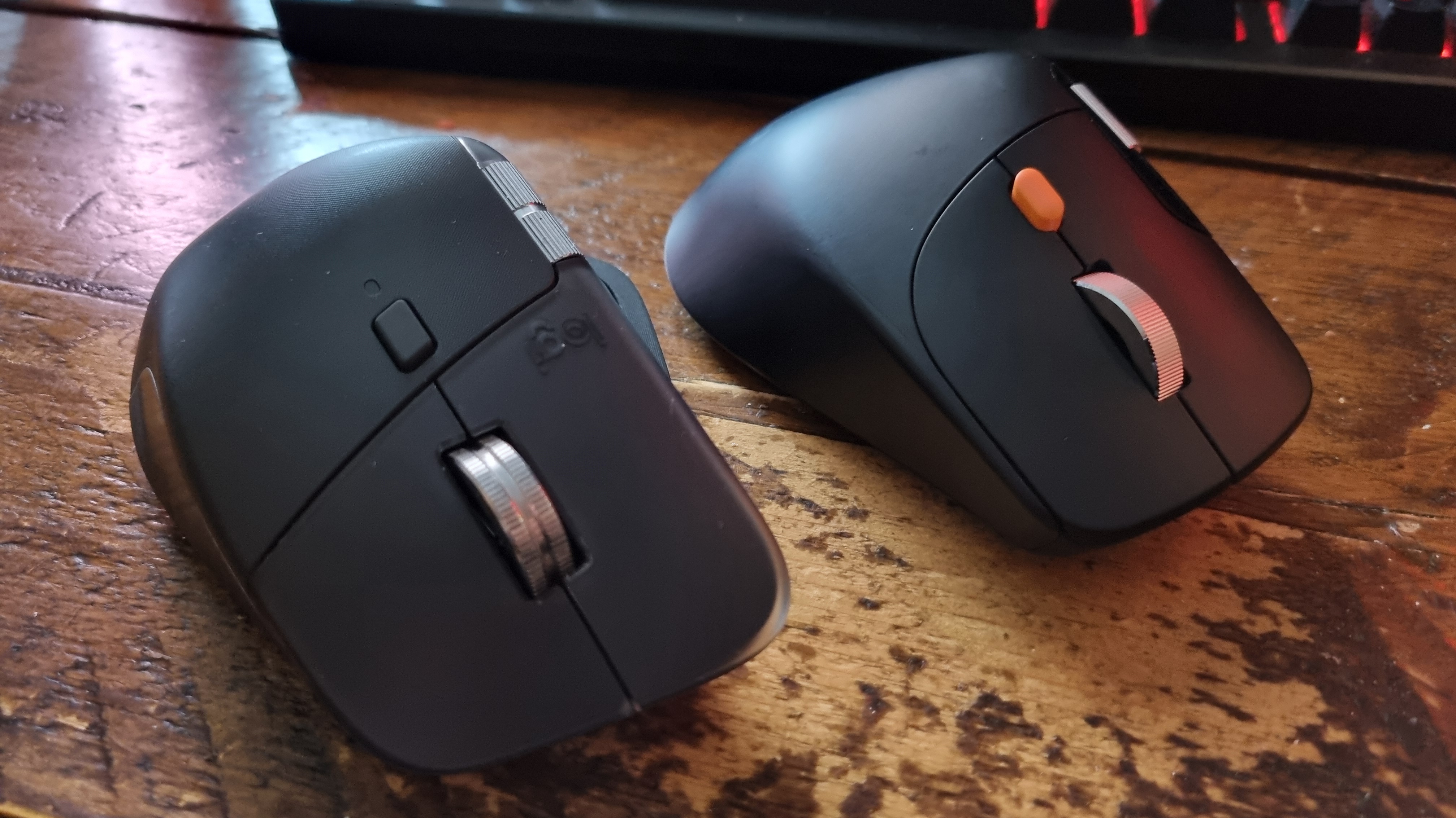 A ProtoArc EM25 ergonomic mouse next to a Logitech MX Master 4