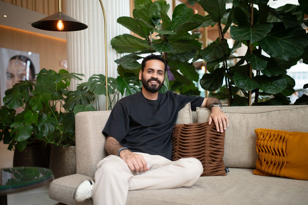Portrait of a man sat on a sofa in a plush hotel
