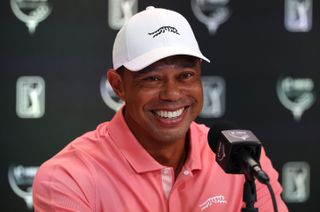 Tiger Woods smiles during a press conference