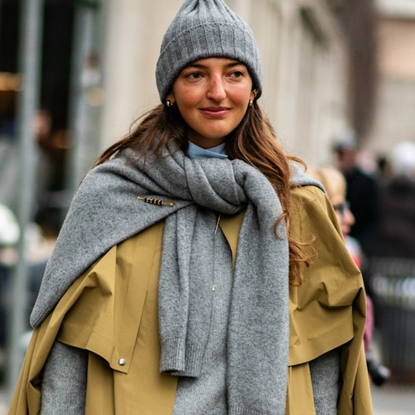 woman wearing a gray hat and trench coat