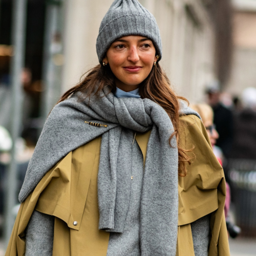 woman wearing a gray hat and trench coat