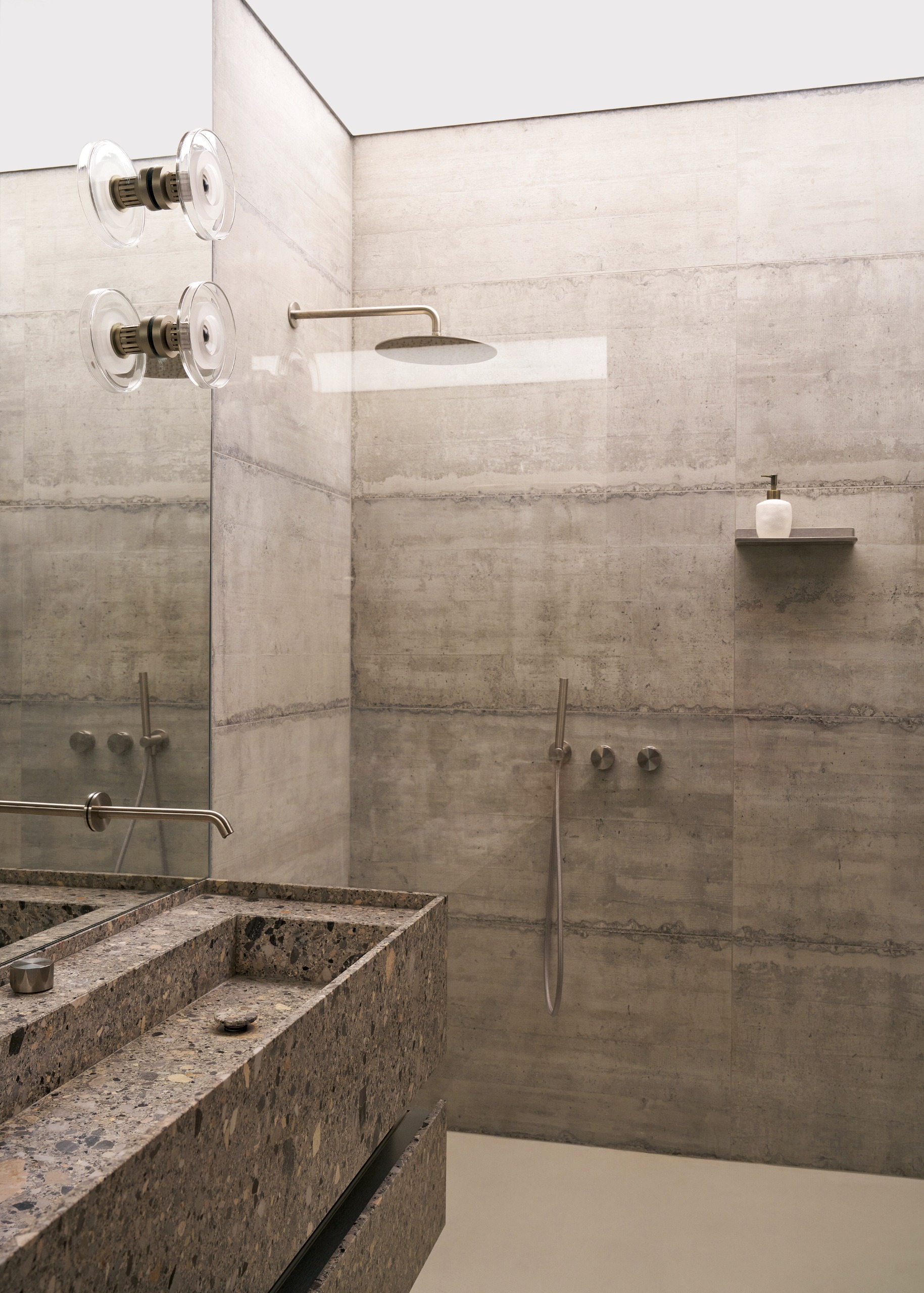 Bathroom with grey concrete walls and terrazzo stone vanity