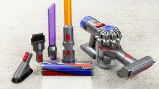 A Dyson vacuum cleaner alongside its accessories