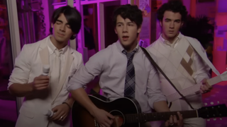 Joe, Nick and Kevin Lucas perform a song on Jonas