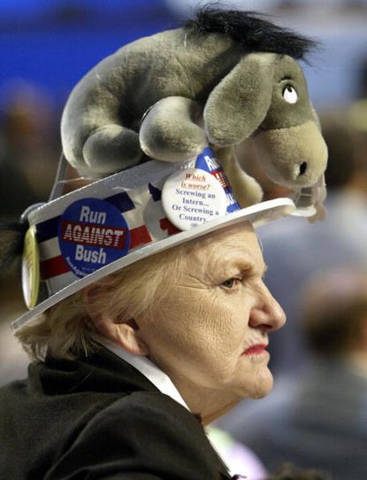Woman wears a stuffed donkey hat to represent the Democratic Party.