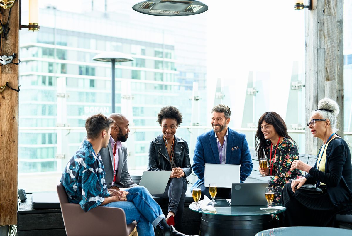 Group of co-workers relaxing with drinks after conference event