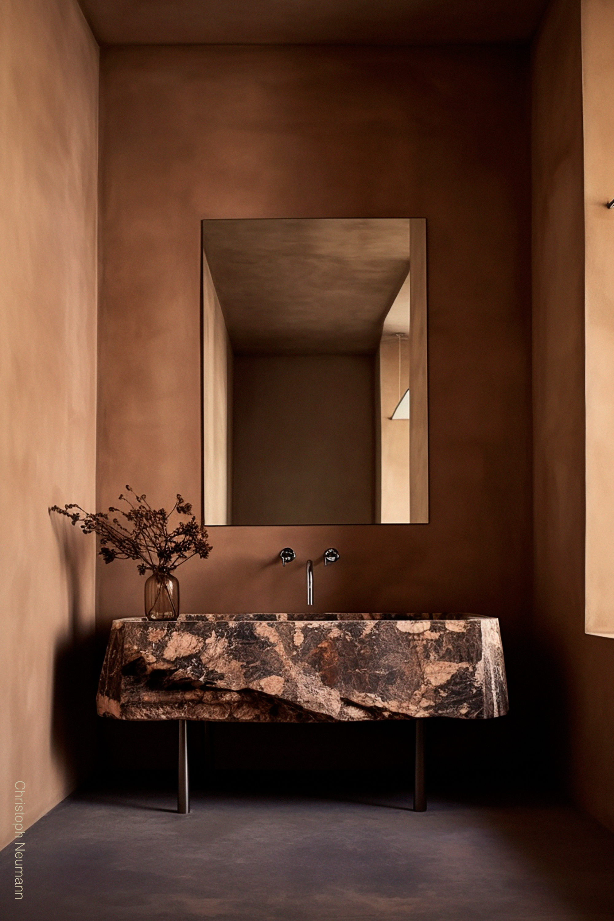 Terracotta limewash paint by Bauwerk Colour featured in a bathroom with a coordinating marble sink