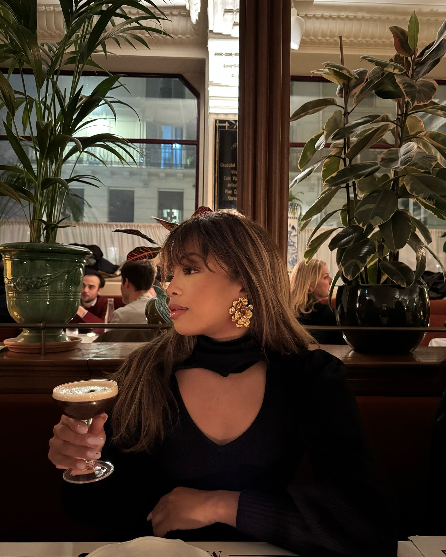 Fashion person Ellie Delphne wears best statement earrings. She wears floral earrings.