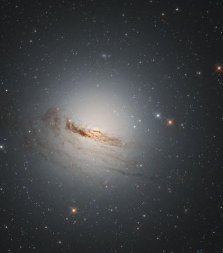 In this image captured by the Hubble Space Telescope, you can see the galaxy NGC 1947, a lenticular galaxy or disc galaxy that's lost most of its interstellar matter. Lenticular galaxies, because of their lost matter, don't have a lot of star formation happening within them. This galaxy was discovered almost 200 years ago and rests in the constellation Dorado (The Dolphinfish) 40 million light-years from Earth.