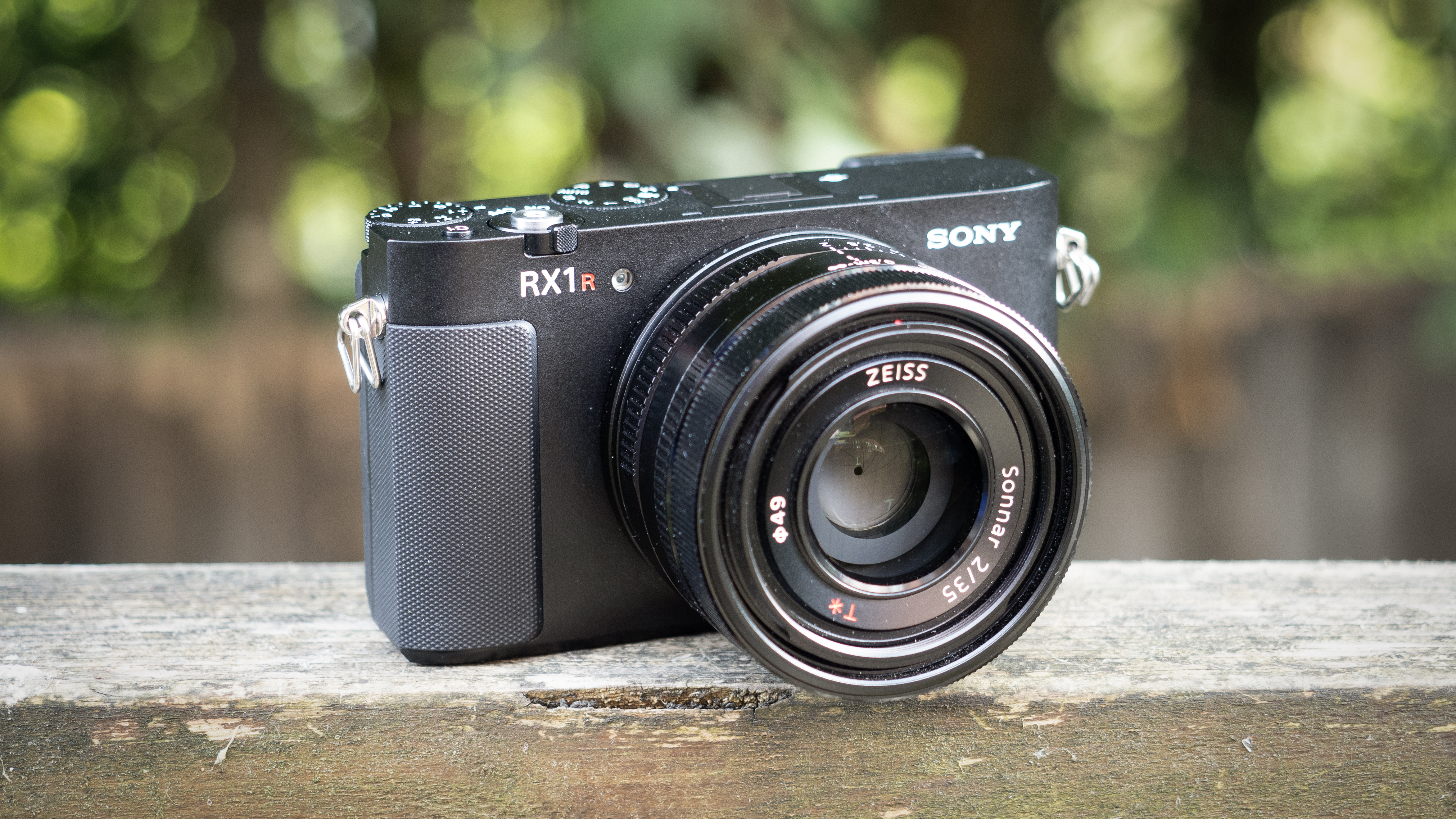 Sony RX1R III on a wooden surface in a woodland environment