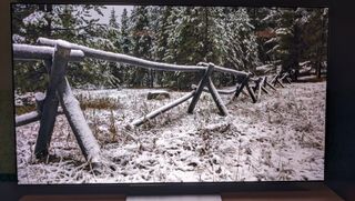 LG G3 with snowy scene and wooden fence on screen 