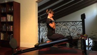 Total Gym XLS review: An image showing a woman using the glideboard to work-out her upper body