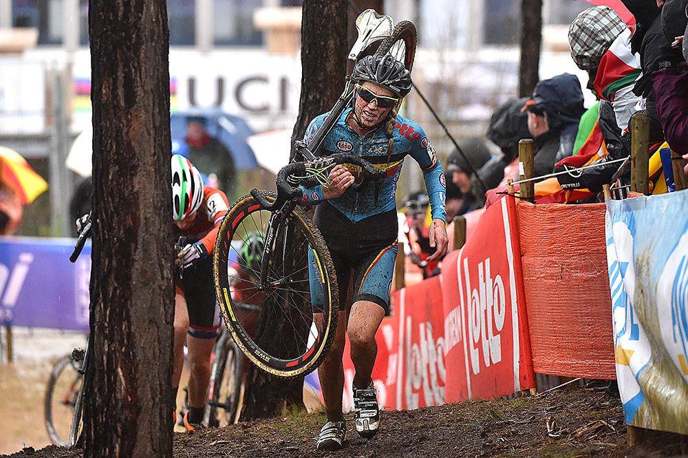 Femke van den Driessche (Belgium) carrying her bike