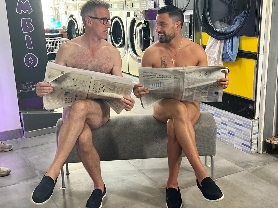 Anton and Giovanni strip off in a laundrette with just a newspaper to cover their modesty in Anton and Giovanni’s Adventures in Spain