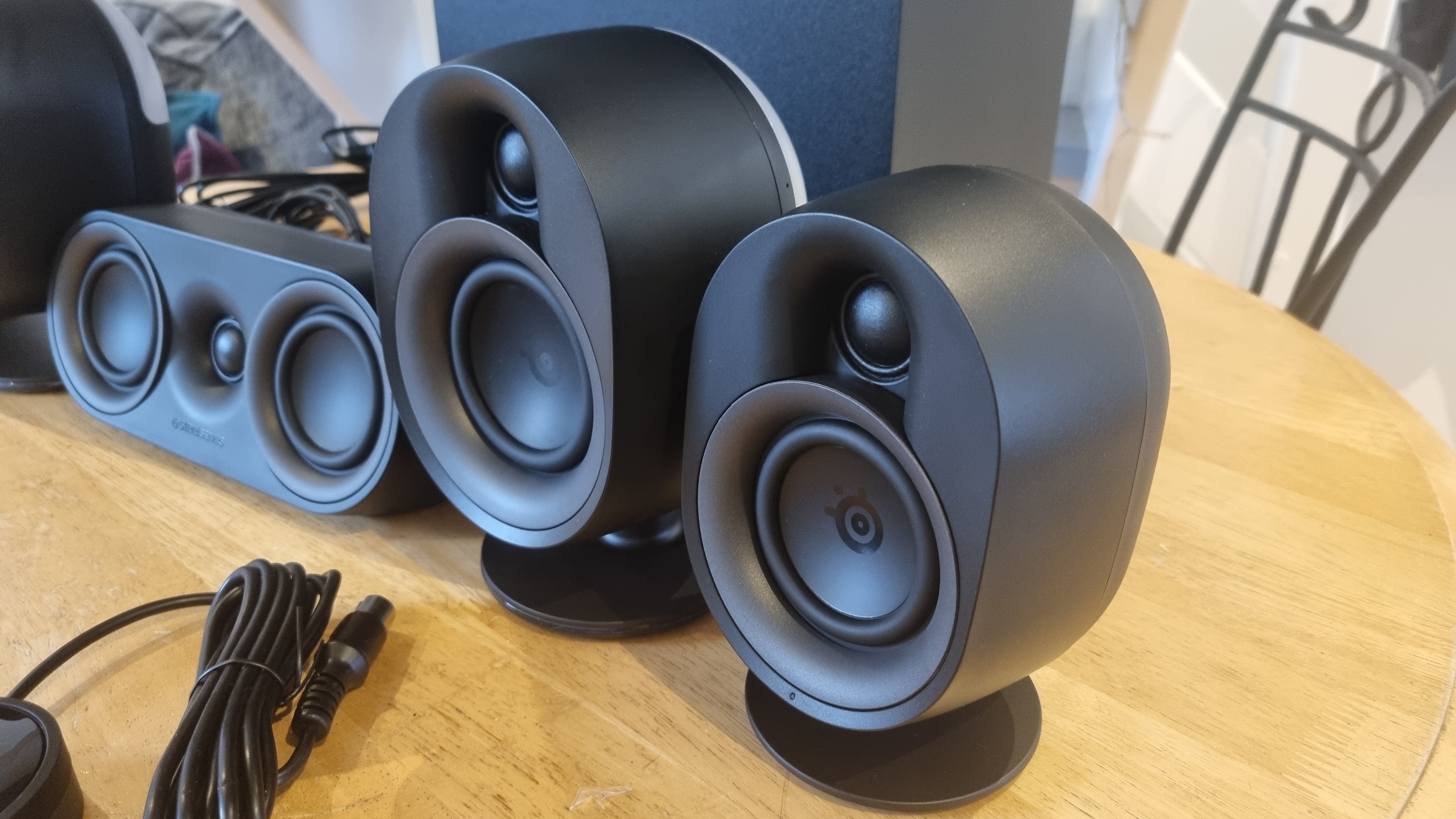 The front left and rear left speakers of the SteelSeries Arena 9, showing the size difference between the two