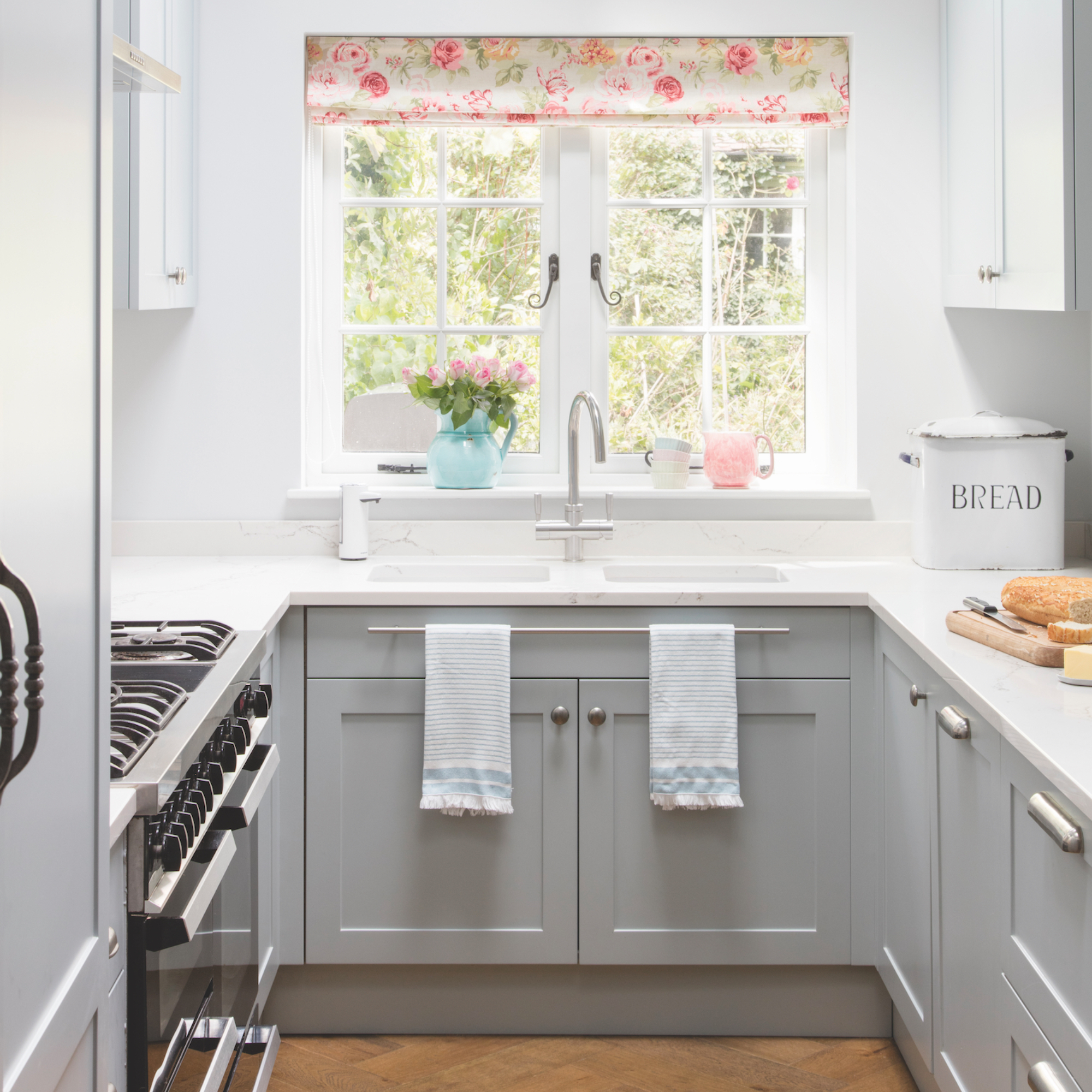 kitchen with sink area and tea towels hanging on rail