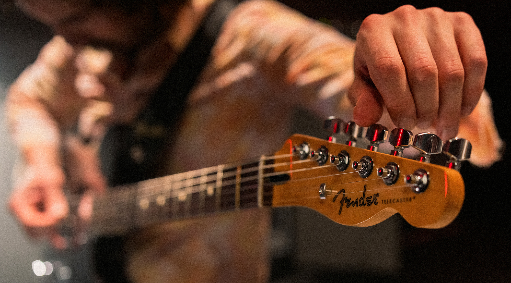A photo of Mark Bowen, guitarist with the band Idles, playing a Fender Player II Modified Telecaster