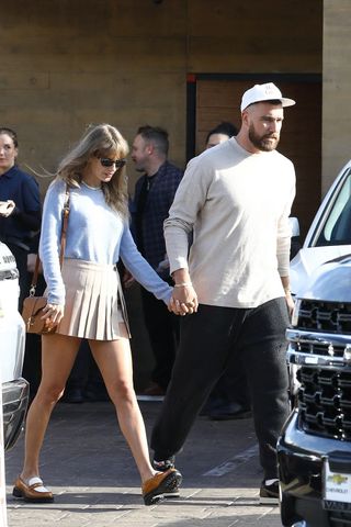 Taylor Swift and Travis Kelce walking hand in hand