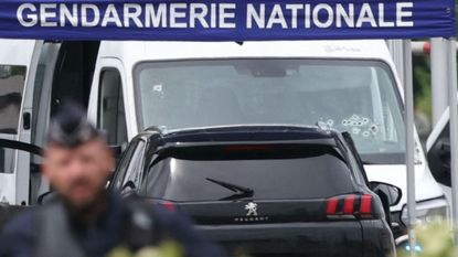 A bullet-ridden prison van is pictured at the site of a ramming attack which took place late morning at a road toll in Incarville in the Eure region of northern France