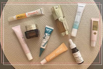 eye cream bottles including No7, Estee Lauder, Boots and The Ordinary scattered on a wooden background 