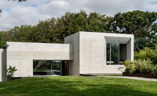 outside of a house with concrete walls and glass window