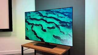 The Philips OLED808 TV viewed at a slight angle with an image of a green sea on the screen.
