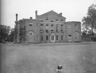 Exterior of Royal Lodge with a dog in front