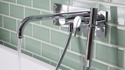 Silver tap over white sink in bathroom