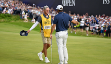 Scottie Scheffler hugs his caddie