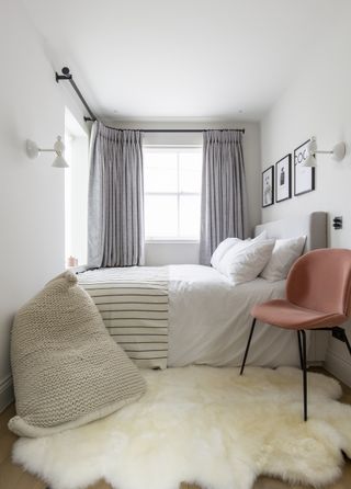 Small guest bedroom with sheepskin rug TR Studio