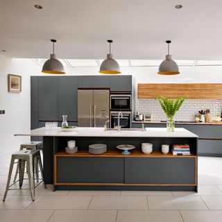 grey kitchen island with white countertop and grey cabinets, white tiled floor