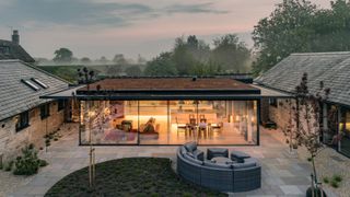 converted barns with large glass extension in between linking the buildings together