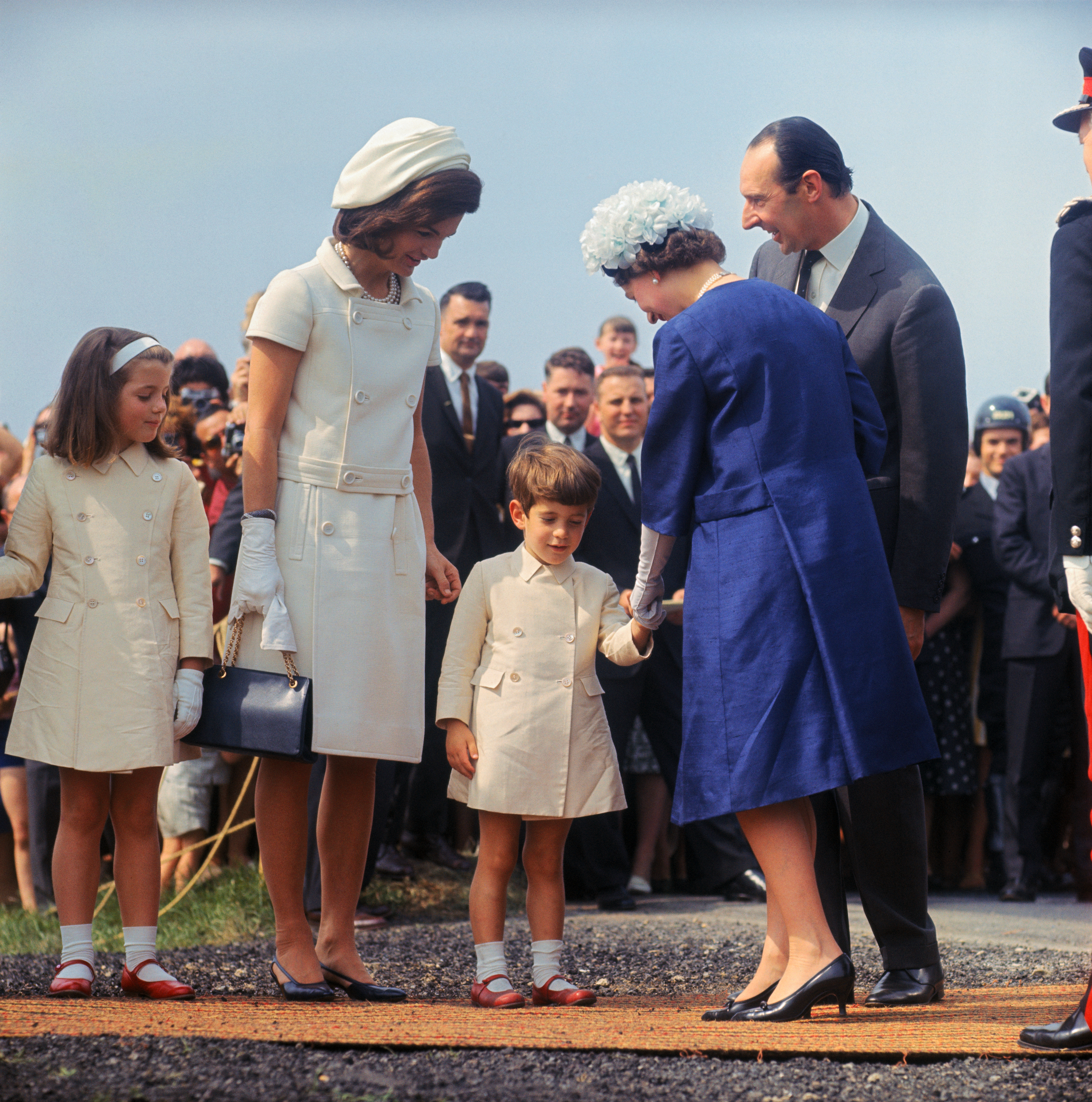 John Kennedy, Jr. shyly bows before Queen Elizabeth at Runnymede, during inauguration of John F. Kennedy Memorial, May 14, 1965